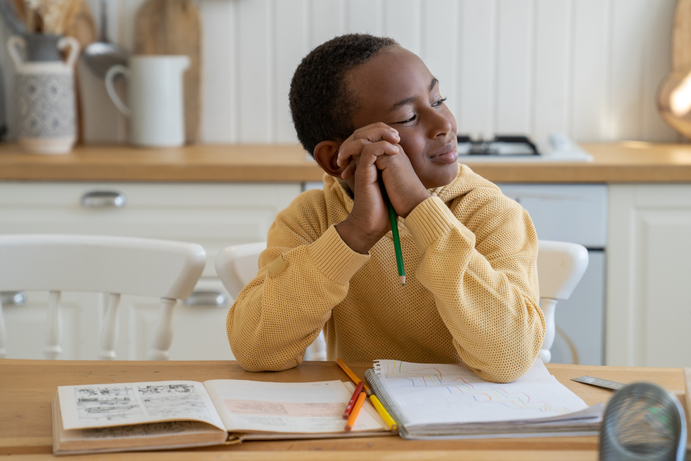 Smiling Dreamy Child African American Boy Procrastinating on Doing Homework