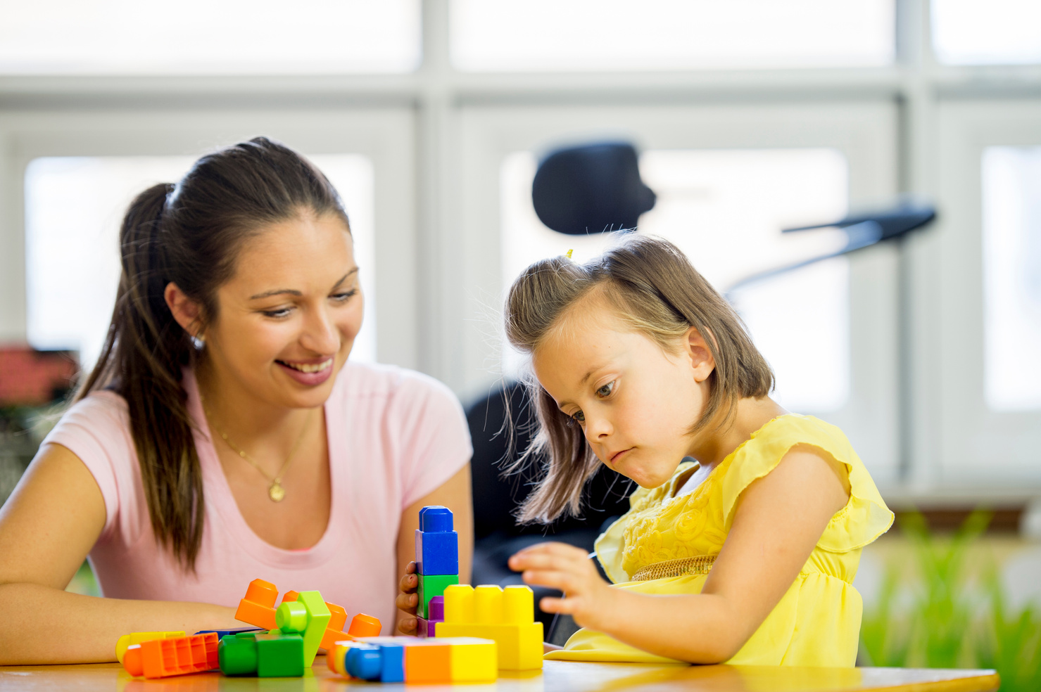 Mentally Handicap Child Playing with Building Blocks